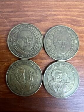 Four collectible promotional coins from the Sunoco Millennium Coin Series